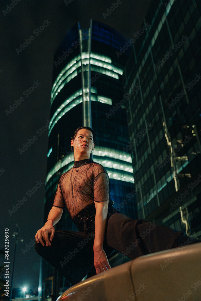 Model in black bold clothes crouching Model in black bold clothes crouching