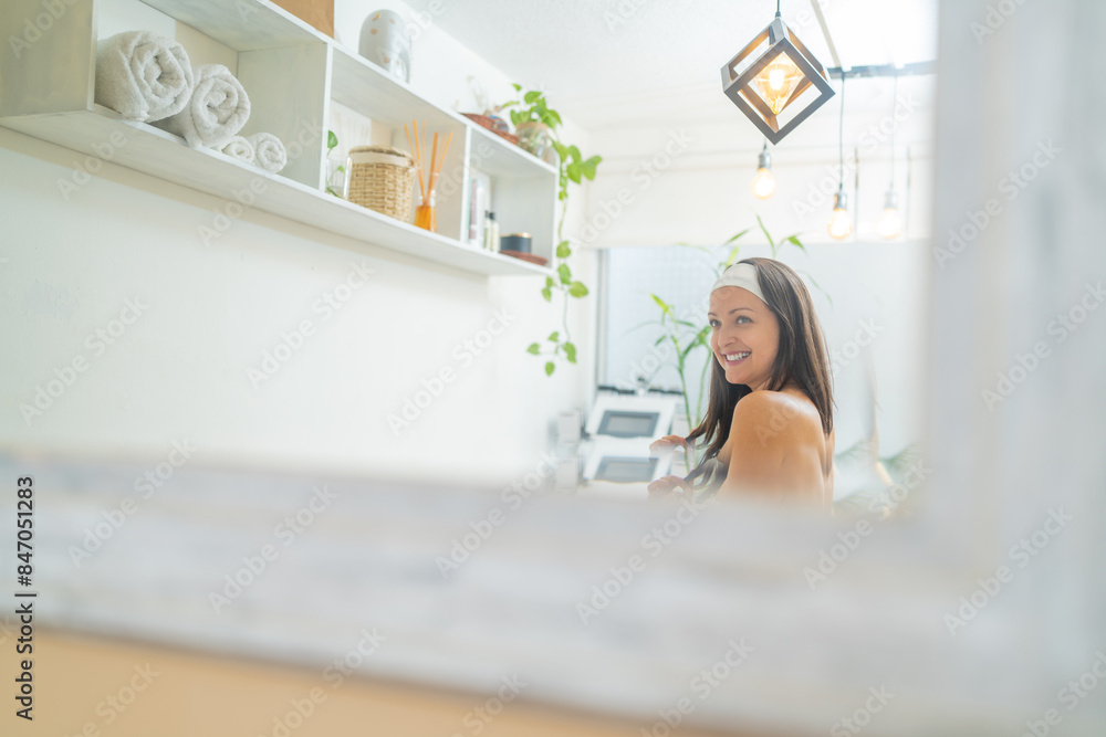 Happy latin young woman standing in a health wellness spa Happy latin young woman standing in a health wellness spa