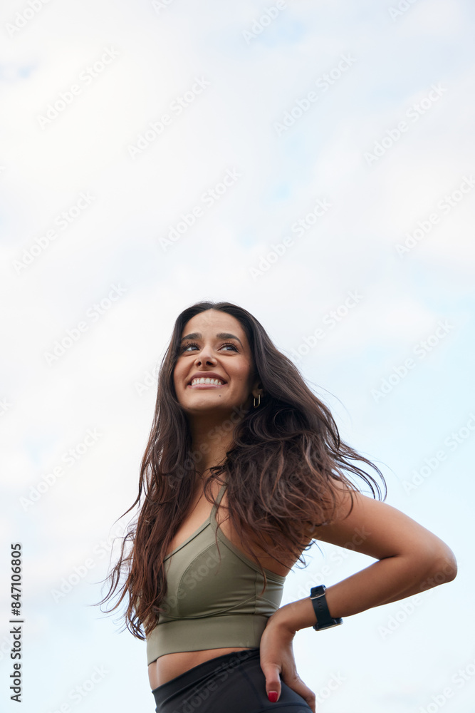 Female hispanic runner posing , arms on hips, big smile, wearing black leggings and a olive top. Female hispanic runner posing , arms on hips, big smile, wearing black leggings and a olive top.