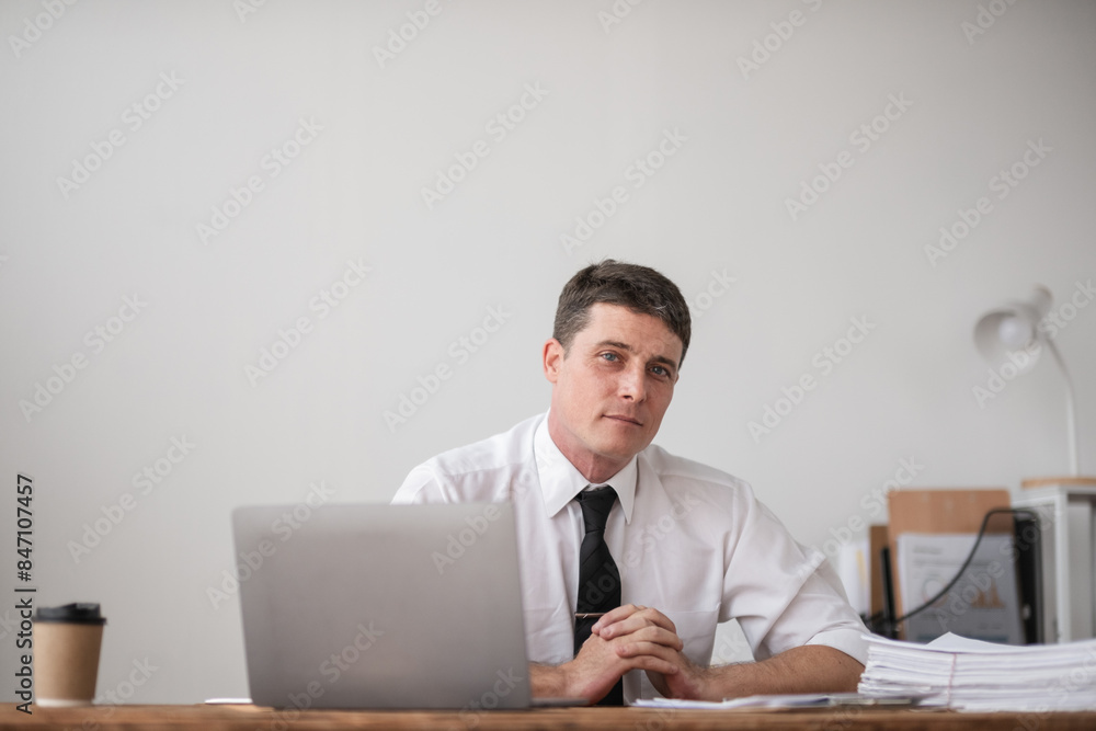 Young Businessman Sitting at Desk Looking Disappointed and Frustrated at Work in Modern Office Environment Young Businessman Sitting at Desk Looking Disappointed and Frustrated at Work in Modern Office Environment