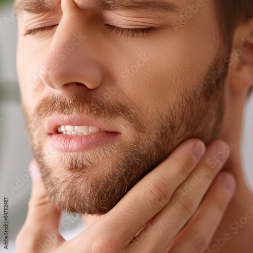 Man Holding His Jaw in Pain with Closed Eyes