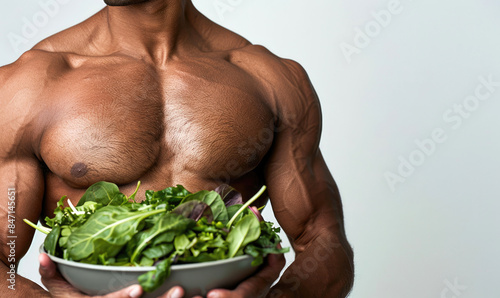 A male athlete is holding a...
