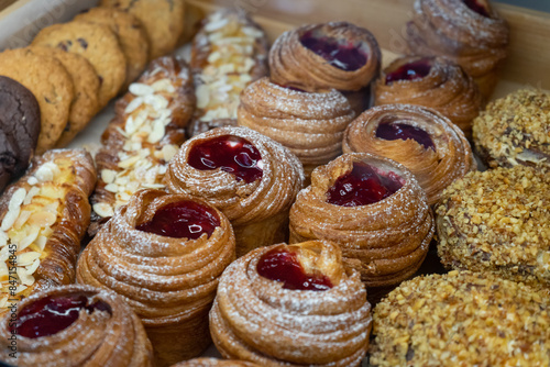 Closeup on fresh pastry, buns and cookies at bakery shop