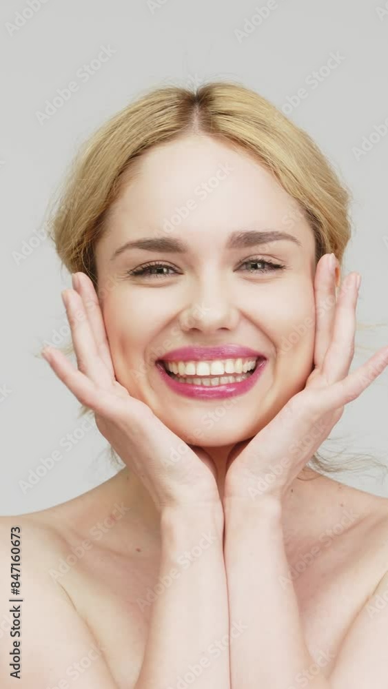 Vertical video. Close-up of a happy blonde girl showing a snow-white, beautiful smile against a light background. Concept of dental services and dental care products. Vertical video. Close-up of a happy blonde girl showing a snow-white, beautiful smile against a light background. Concept of dental services and dental care products.