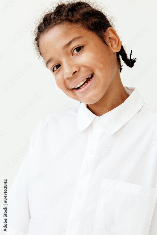 Happy young boy with braided braid and white shirt smiling in trendy style Happy young boy with braided braid and white shirt smiling in trendy style