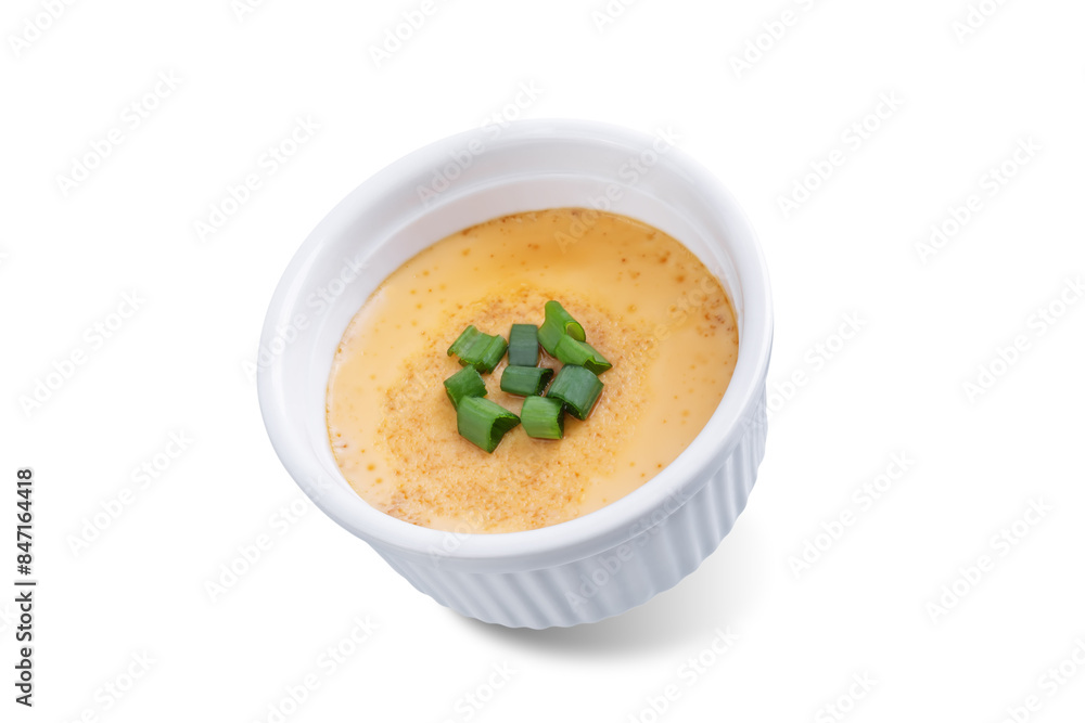 Asian steamed eggs in a bowl with soy sauce and scallions on a white isolated background Asian steamed eggs in a bowl with soy sauce and scallions on a white isolated background