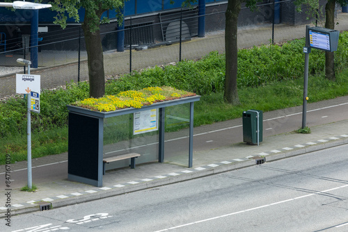 Modern bus stop with roof garden and Bus Stop sign with LED Display destination Utrecht Central Station.
