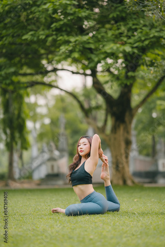 Young asian woman is practicing yoga exercises in the morning, yoga relax outdoor concept © Kritdanai