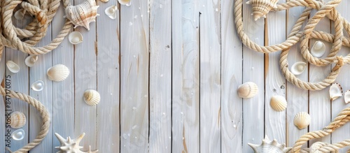 Top view of a white wooden deck adorned with marine rope and seashells, against a serene seascape.