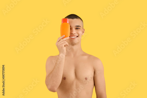 Happy young man with bottle...