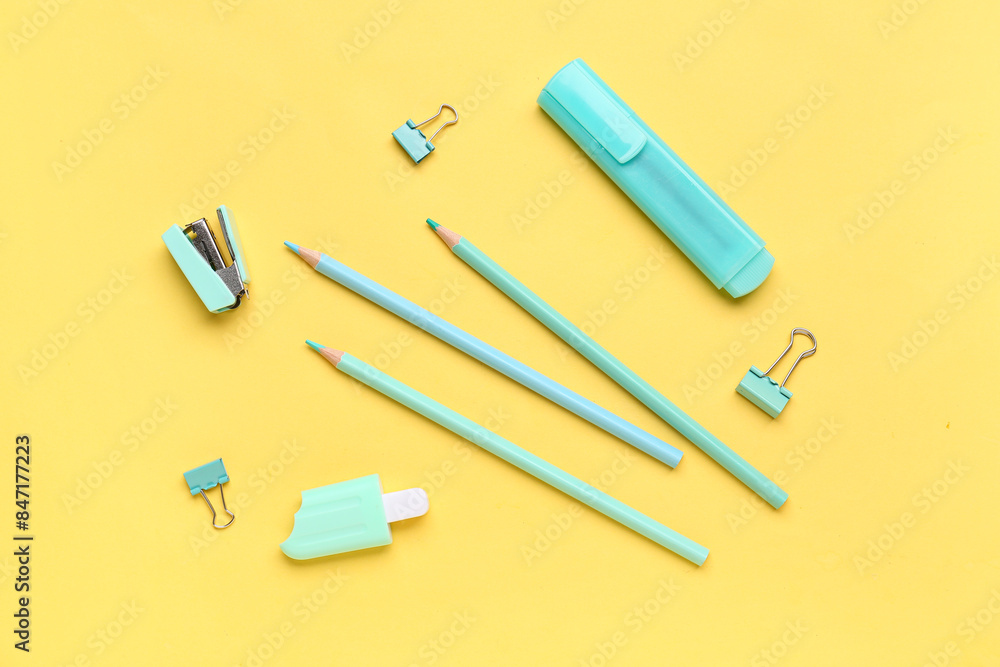 Set of different stationery with pencils on yellow background Set of different stationery with pencils on yellow background