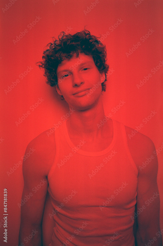 Handsome man looking at camera against red background Handsome man looking at camera against red background