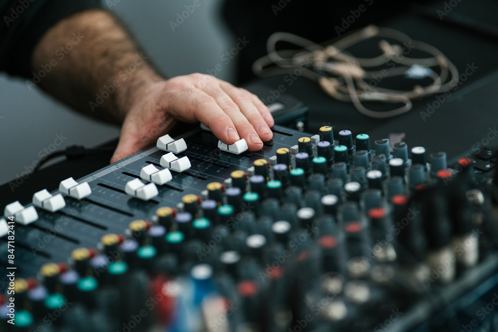 Unrecognizable man with finger on fader Unrecognizable man with finger on fader