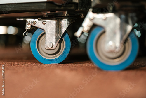Caster roller wheels supported with metal handle