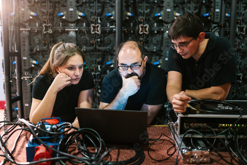 Group of colleagues working with a laptop photo