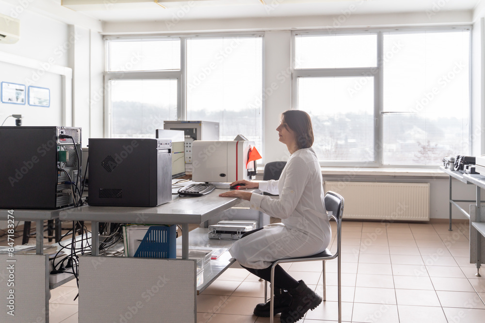 Scientist Working At The Desk In The Lab