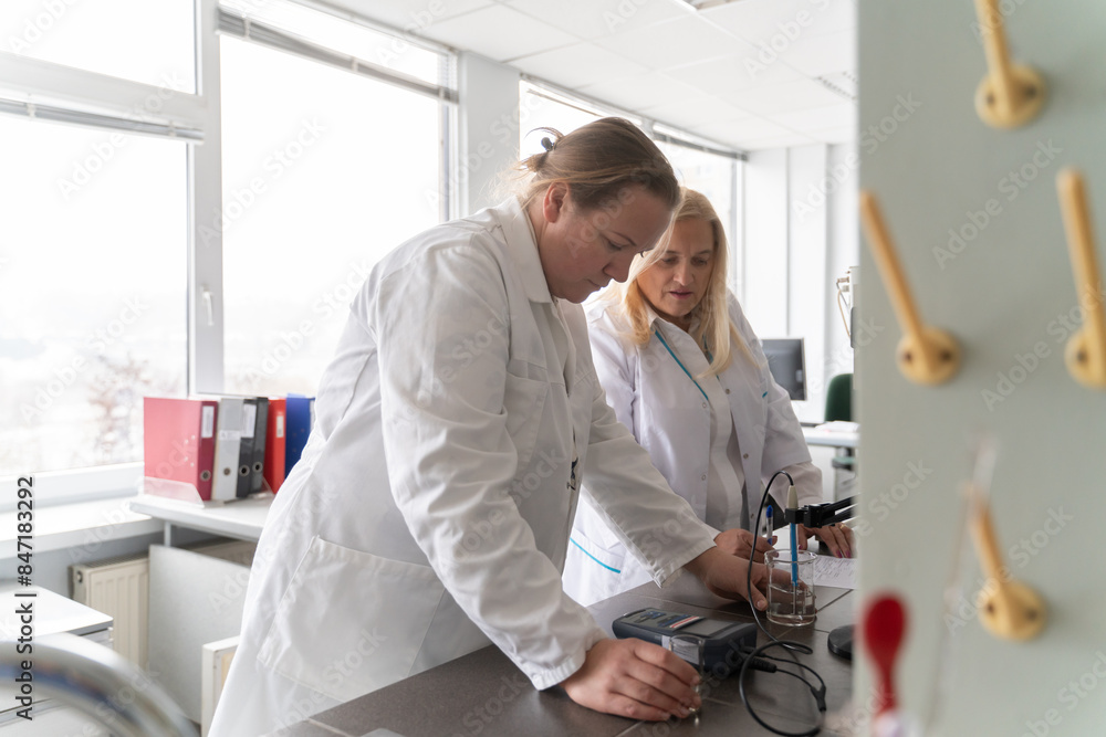 Two Female Researchers Working With Experiment Two Female Researchers Working With Experiment