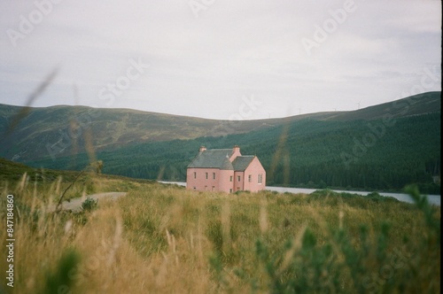 A pink cottage house on Loch Glass, Scotland, 35mm film. photo