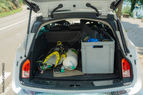 Gear for diving with aqualung packed in truck of car 