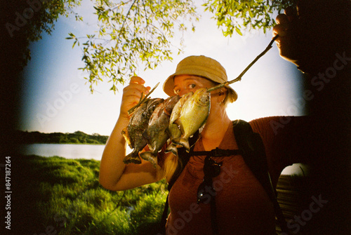 Woman holding freshly fished piranhas  photo