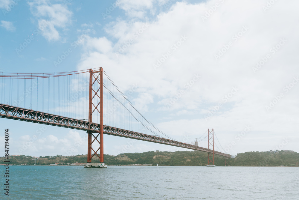 Iconic Red Bridge Over Lisbon Waters Iconic Red Bridge Over Lisbon Waters