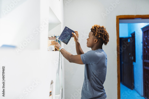 Man Placing Photo on Shelf on library photo