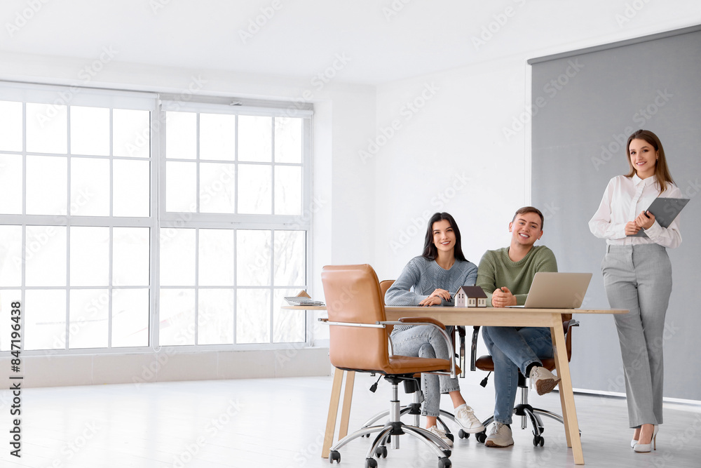 Real estate agent working with couple in office Real estate agent working with couple in office