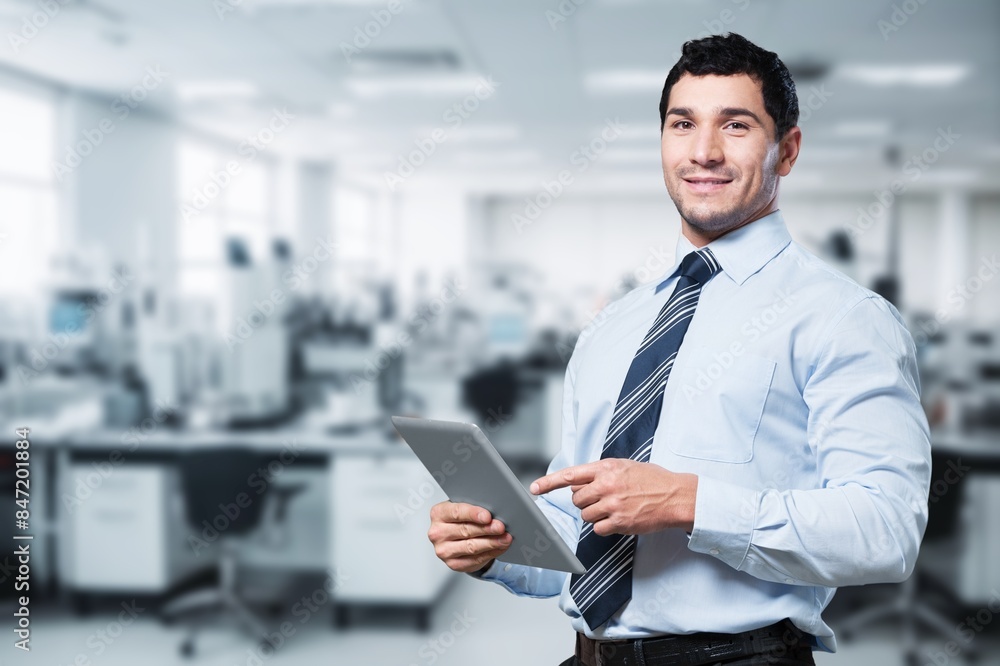 Happy young business man in office. Happy young business man in office.