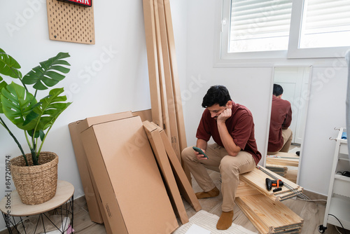 Frustrated man assembling furniture photo