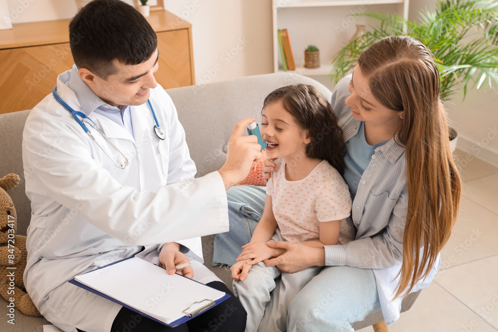 Little girl with her mother and doctor using inhaler at home Little girl with her mother and doctor using inhaler at home