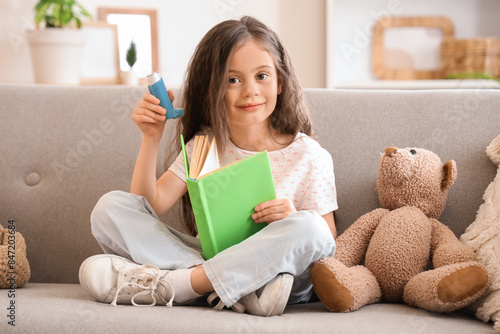 Little girl with inhaler an...