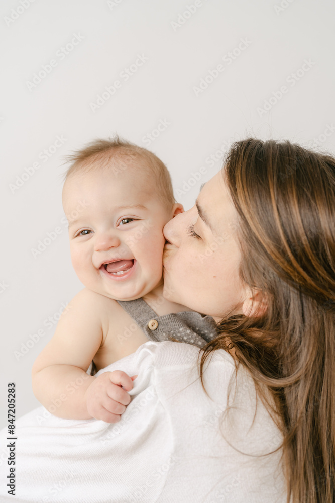 portrait of happy mother with smiling baby in studio portrait of happy mother with smiling baby in studio