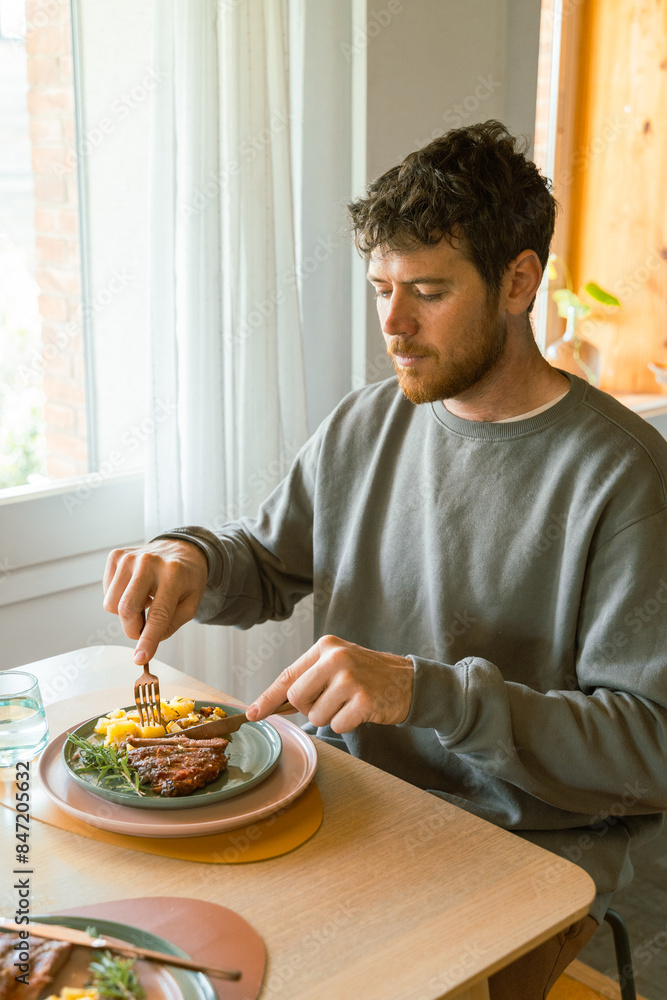 Man eating meal at home Man eating meal at home