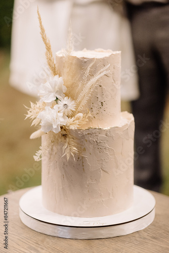 Elegant Two-Tiered Wedding Cake Adorned With White Flowers 