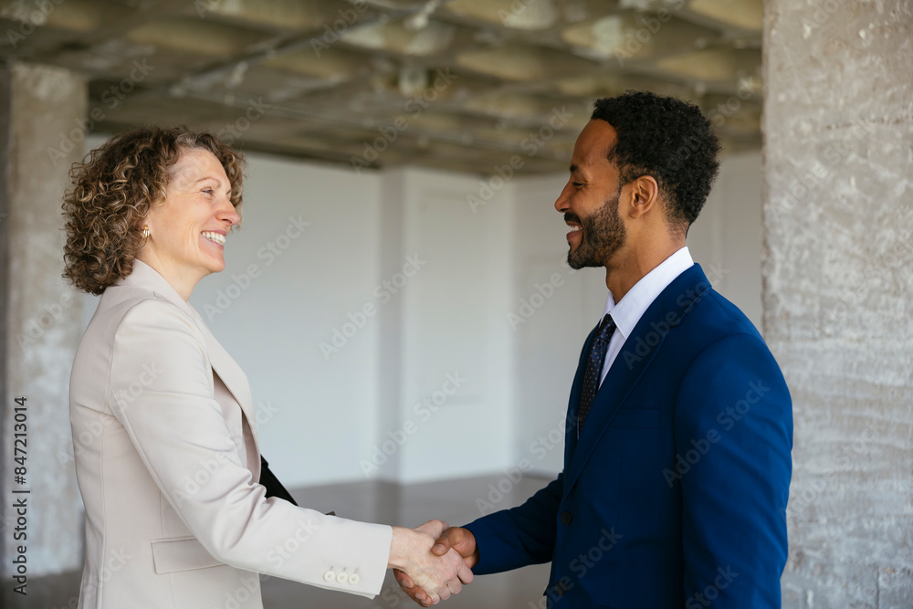Estate agents shaking hands at new loft for sale Estate agents shaking hands at new loft for sale