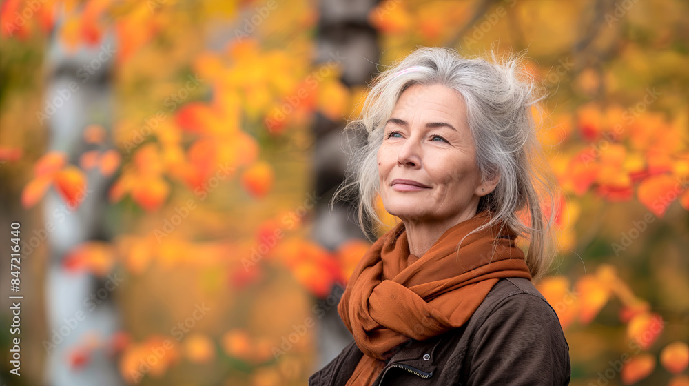 Serene Mature Woman Enjoying Autumn Colors in a Peaceful Park Serene Mature Woman Enjoying Autumn Colors in a Peaceful Park