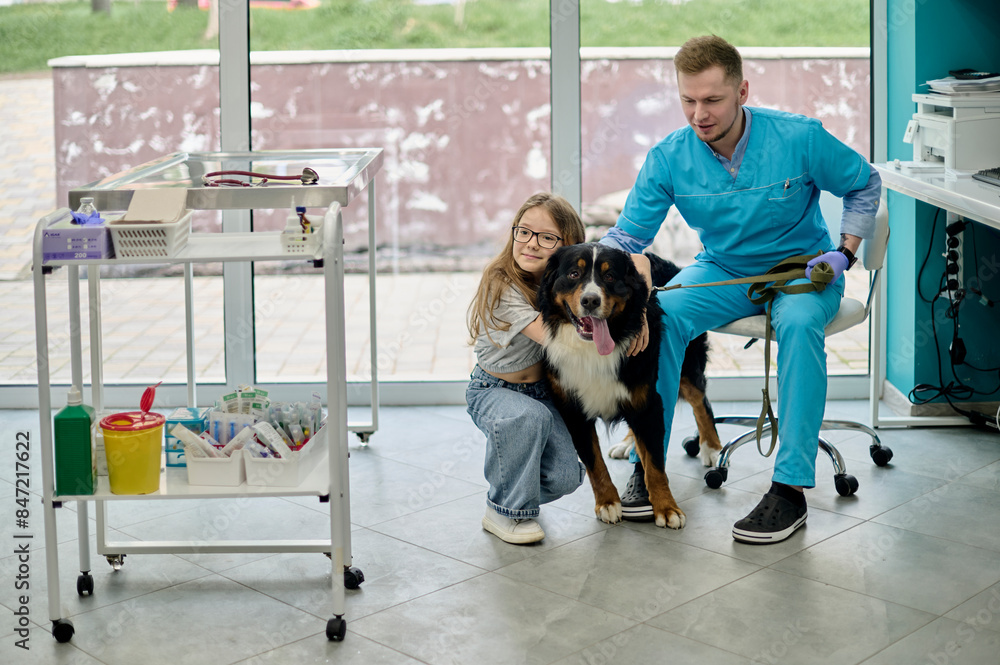 a little girl with her pet at a veterinary clinic appointment a little girl with her pet at a veterinary clinic appointment