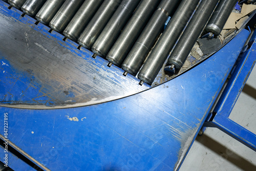 An empty industrial roller conveyor belt in a fully automated factory. roller conveyor to easily move heavy industrial goods around without the need for humans.future of industrial manufacture.