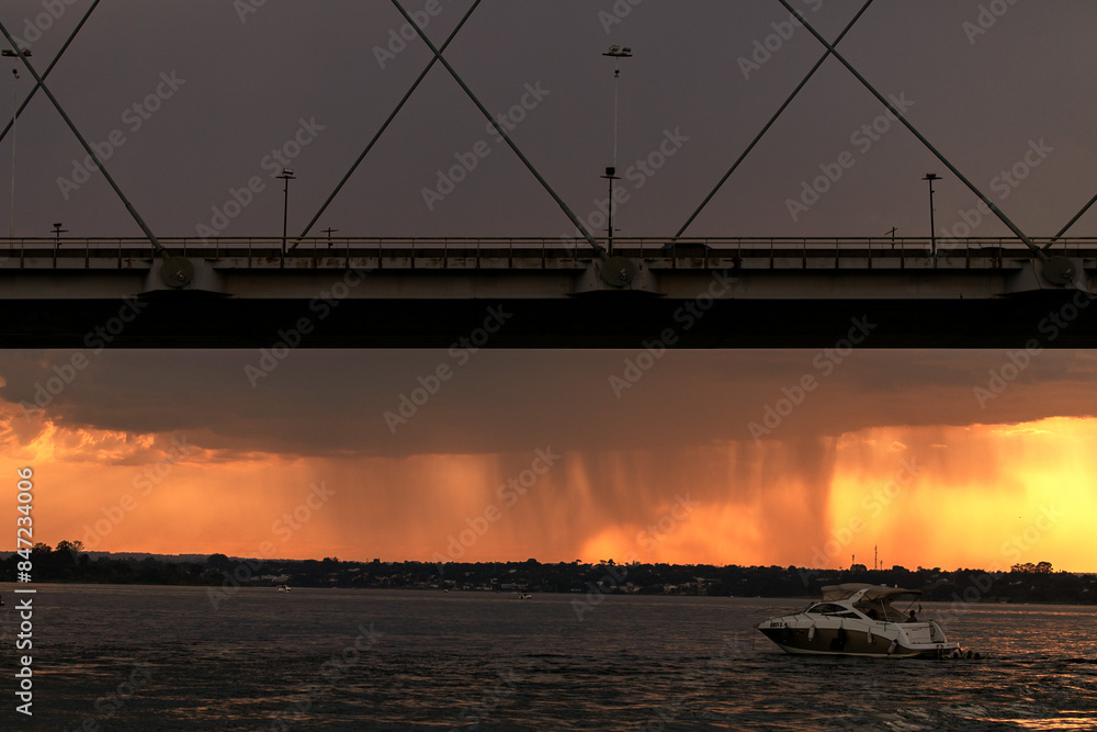 Obraz premium Sunset over the Paranoa Lake with rain in the background