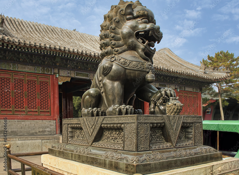 Naklejka premium Stone lion representing the guardian of the Hall of Benevolence and Longevity, within the Summer Palace complex in Beijing, China