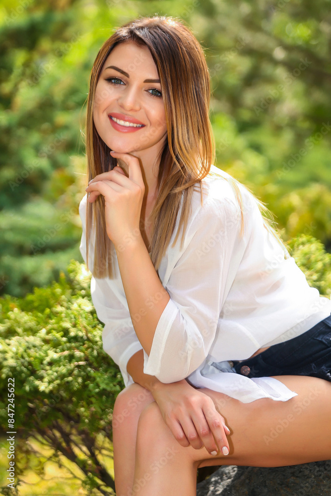 Portrait of a beautiful fashion model blonde girl in the nature with makeup and hairstyle against the background of green birches trees Portrait of a beautiful fashion model blonde girl in the nature with makeup and hairstyle against the background of green birches trees