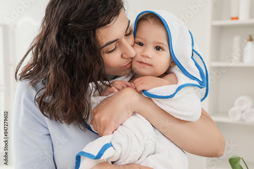 Mother kissing her baby in ...