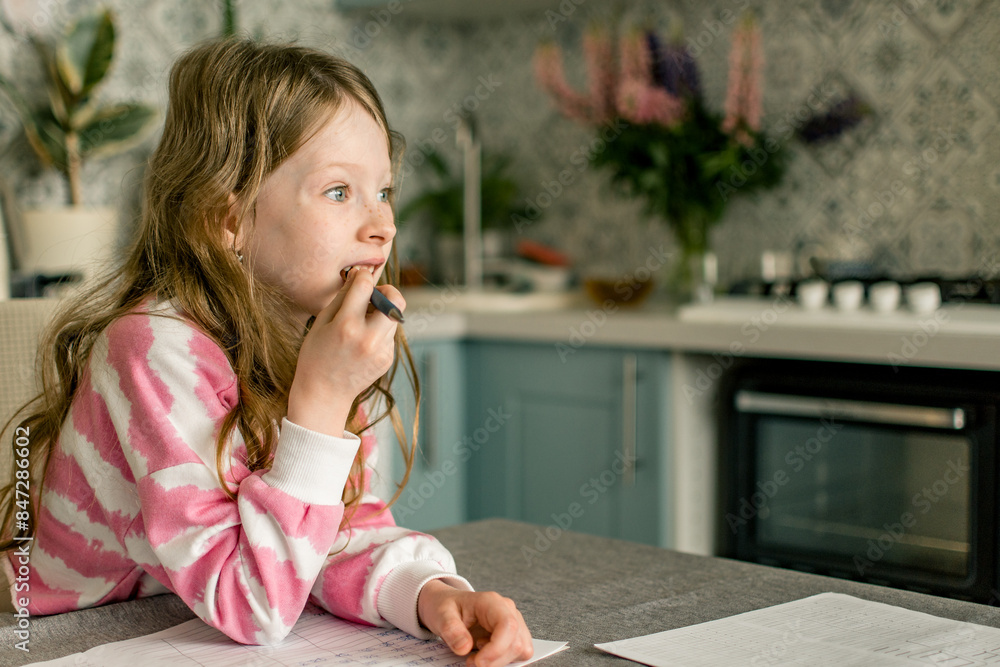 School girl going homework at home, writing in notebook. School girl going homework at home, writing in notebook.