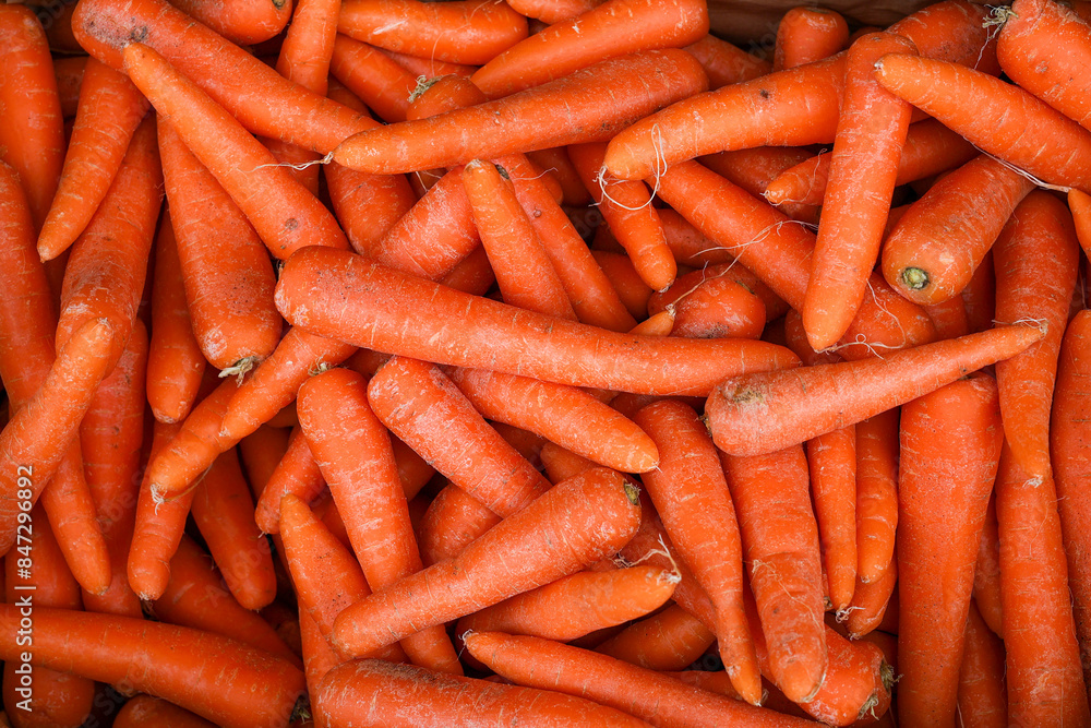 Detail background of orange raw carrots freshky harvested in a top view heap. Detail background of orange raw carrots freshky harvested in a top view heap.