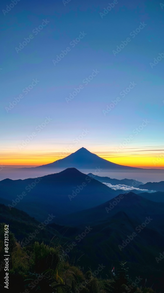 Obraz premium Aerial Drone View of Mountain Silhouette at Sunrise from the Top