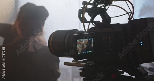 The cameraman with a professional movie camera at work.