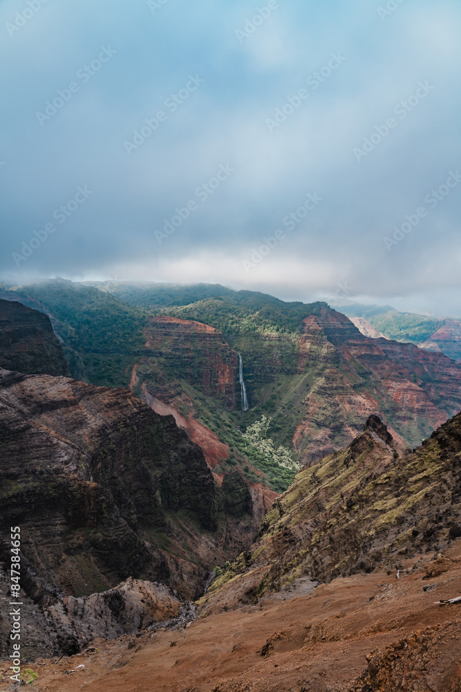 Naklejka premium Waipo'o Falls, Waimea Canyon State Park, Kauai, Hawaii. Waimea Canyon, also known as the Grand Canyon of the Pacific, 