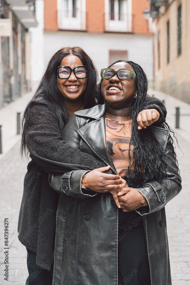 Two friendly women laughing together on the street Two friendly women laughing together on the street
