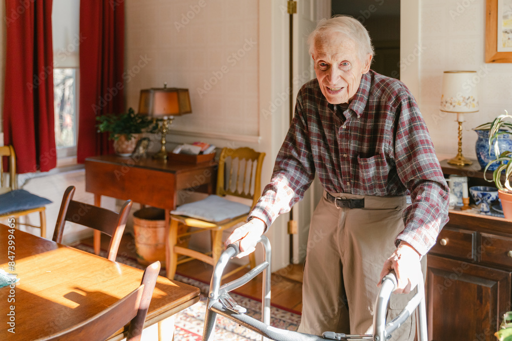 elderly man/ senior citizen walking in his home elderly man/ senior citizen walking in his home