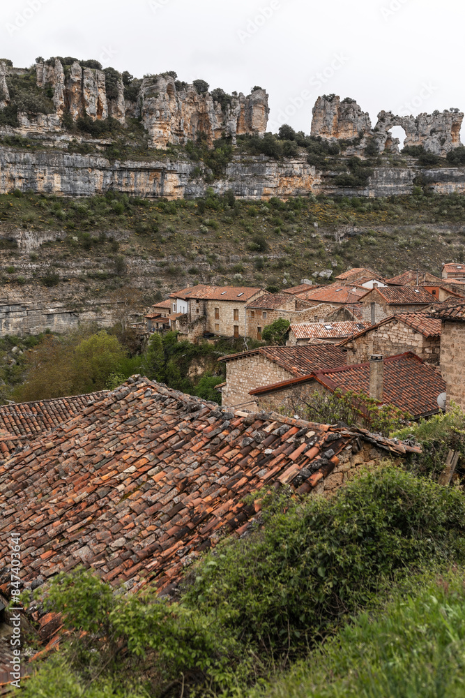 landscape of a rural town surrounded by rocky mountains landscape of a rural town surrounded by rocky mountains